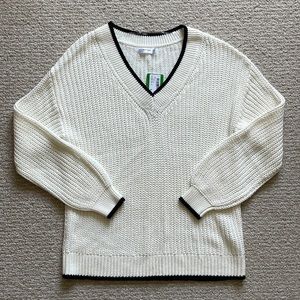 White knit sweater with black trim